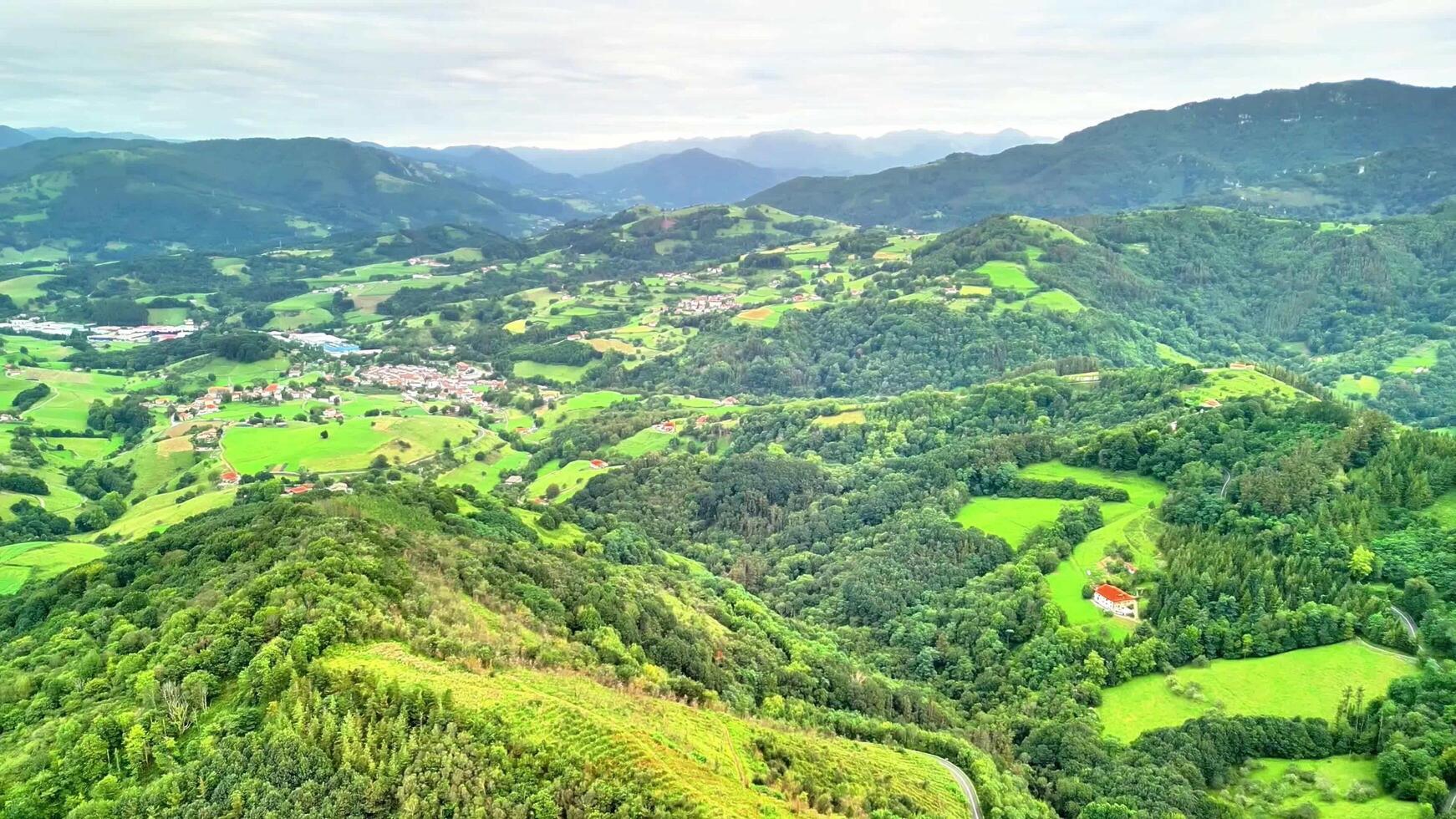 Experience the Stunning Aerial View of Lush Green Hills and Picturesque Villages Below photo