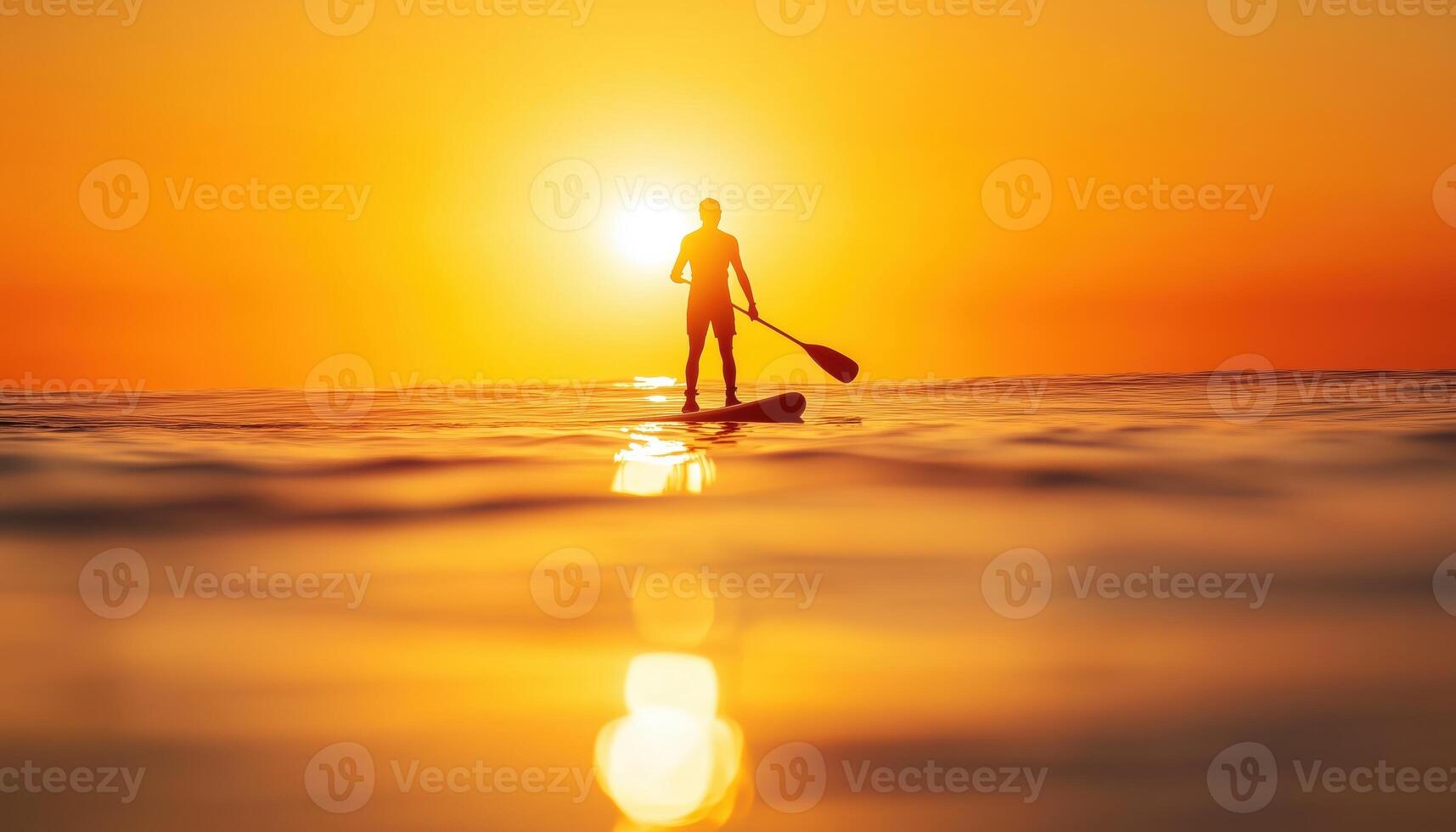 Silhouette Of Stand Up Paddle Boarder Enjoying The Sun On A Warm, Tranquil Sea With A Paddle In Hand. photo
