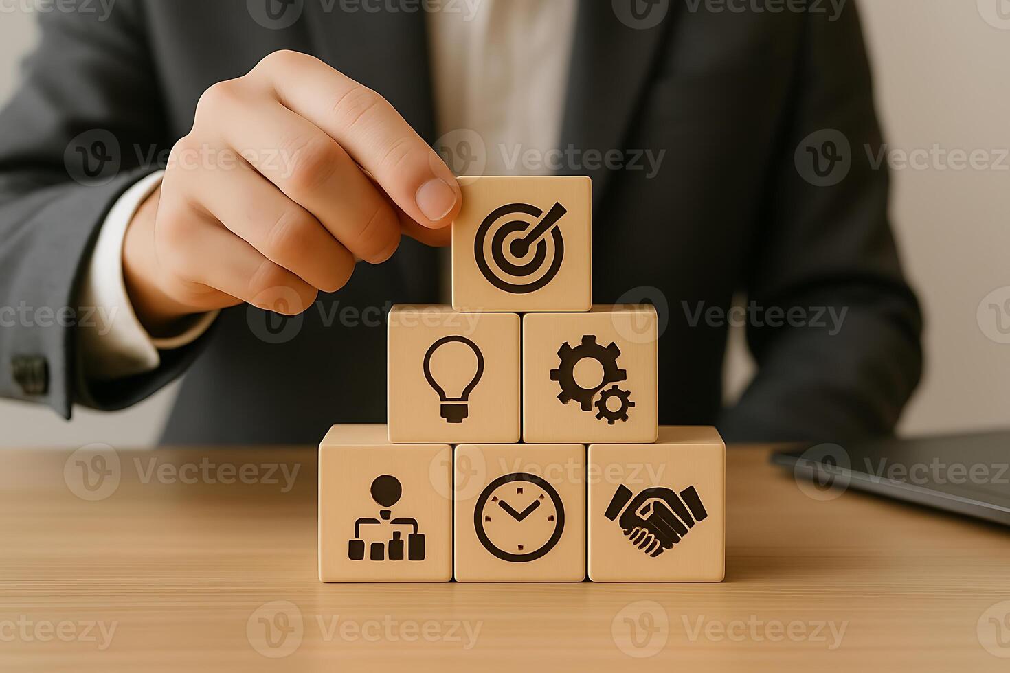 Businessman hand stacking wooden cubes with business icons photo