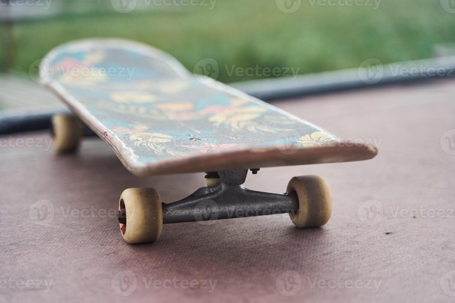 A CloseUp of a Colorful Skateboard Displayed on a Deck with Various Graphics and Colors photo