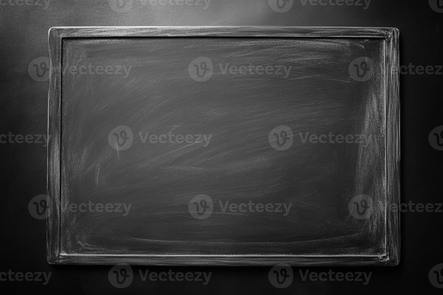 The grey chalkboard presents a blank surface ready for creative writing or drawing, perfect for classrooms or personal use photo