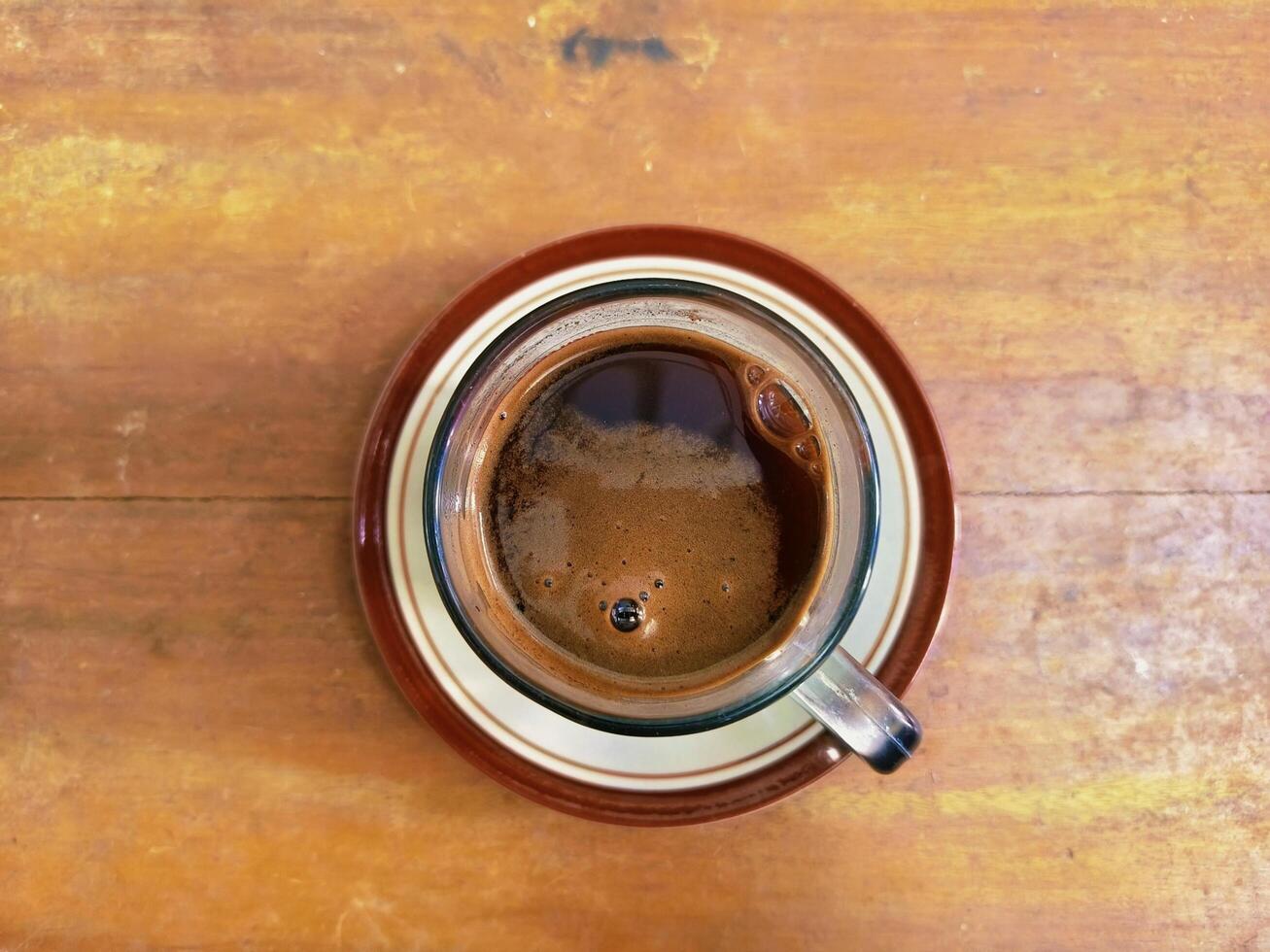Top view of black coffee. flat lay Still life image of black coffee on wood surface photo