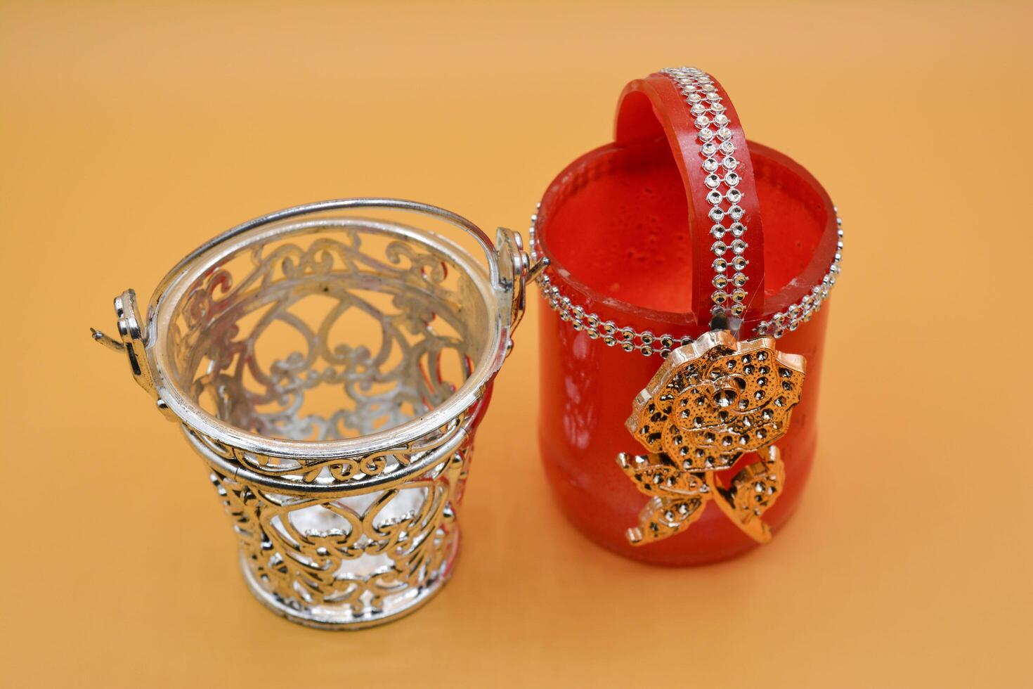 A red and silver vase with a silver handle photo
