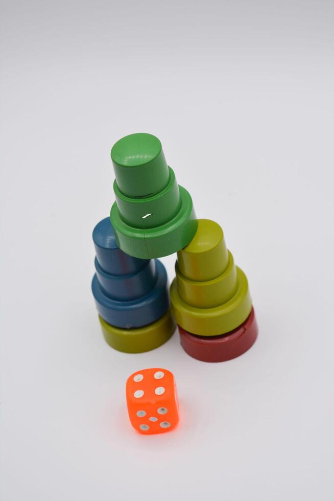 A stack of colorful dice and a stack of plastic cups photo