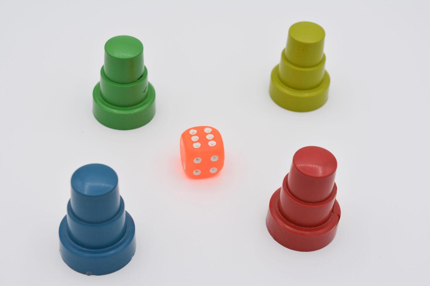 A group of colorful plastic dice on a white surface photo