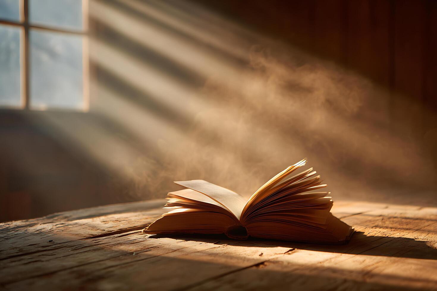 an open book on a wooden table with sunlight streaming through the window photo