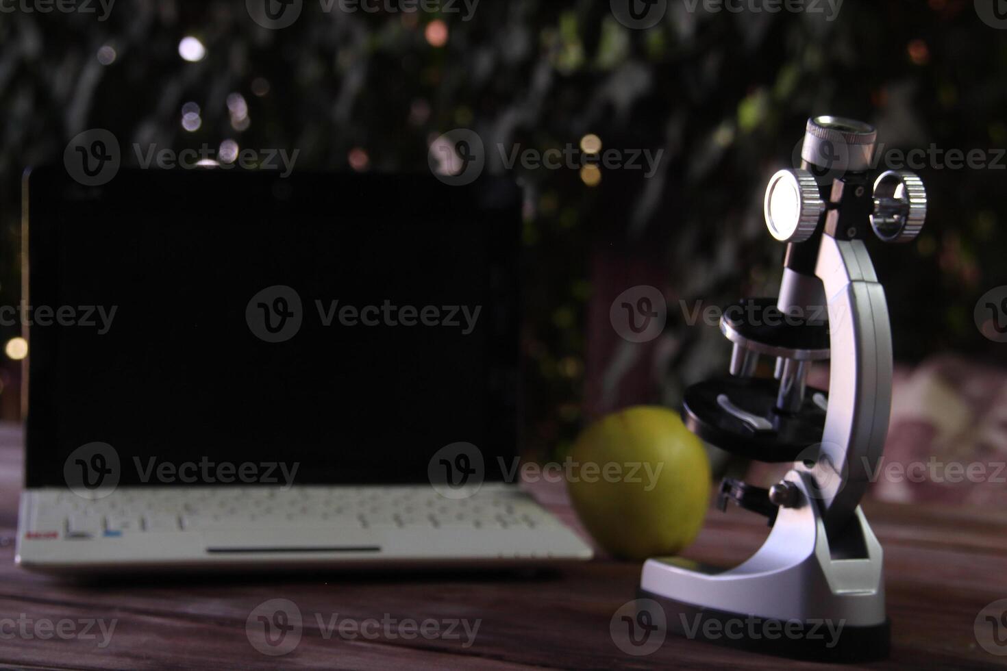 Focus on a microscope standing on a table. photo