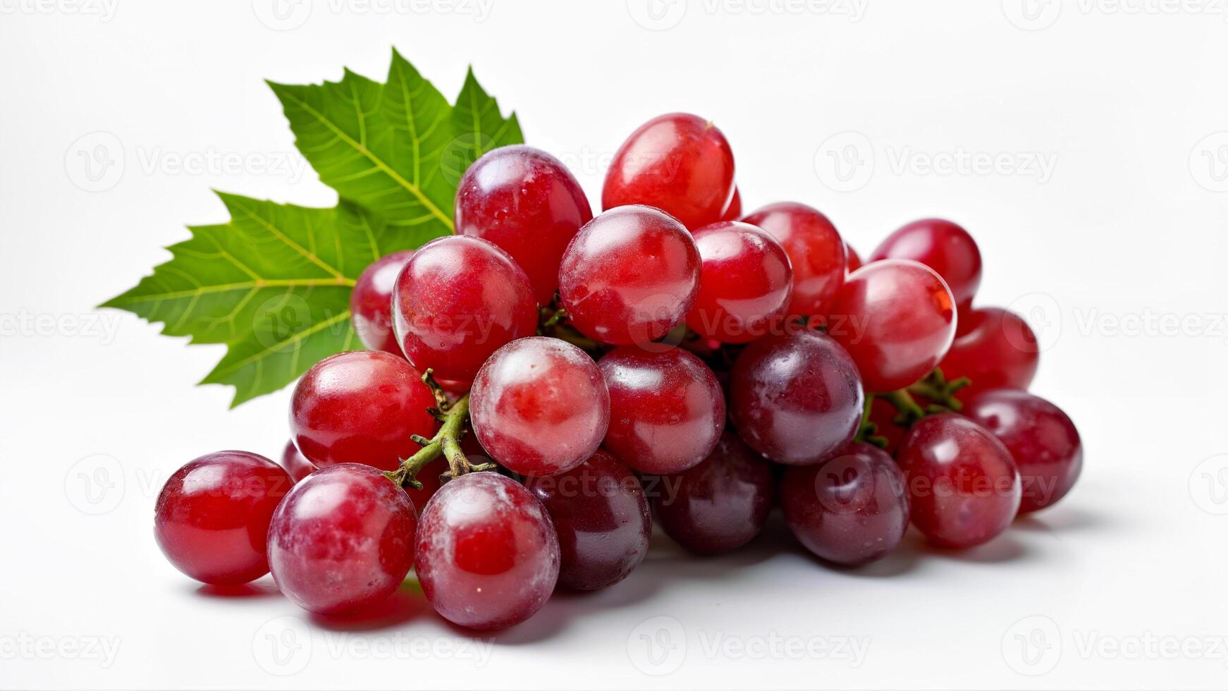 A cluster of juicy red grapes with a green leaf is isolated on a white background. Suitable for food, nutrition, healthy eating, and product packaging concepts. photo