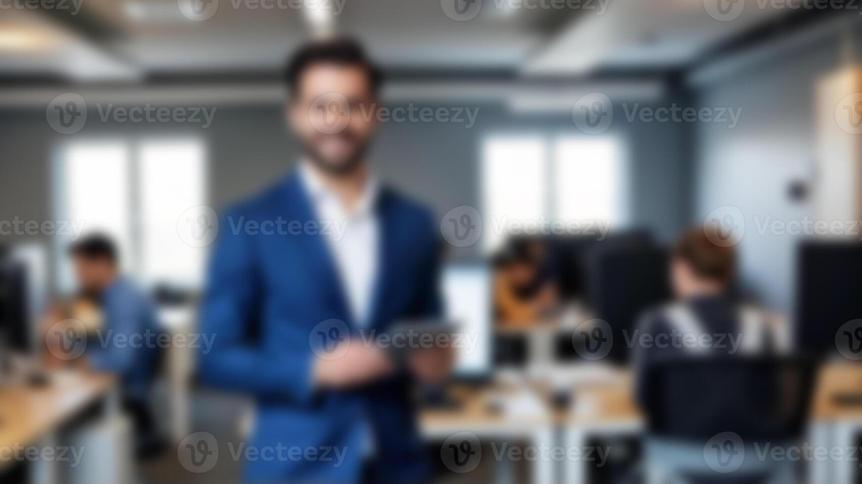 A man in a blue suit is standing in an office photo