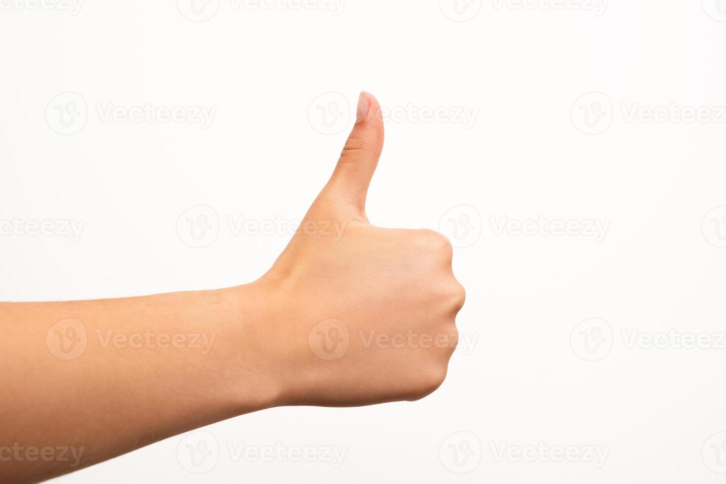 A human hand gives a thumbs up gesture, isolated on a plain white background with clear lighting and no distractions. Suitable for concepts of approval, agreement, success, or positive feedback in digital or print media. photo