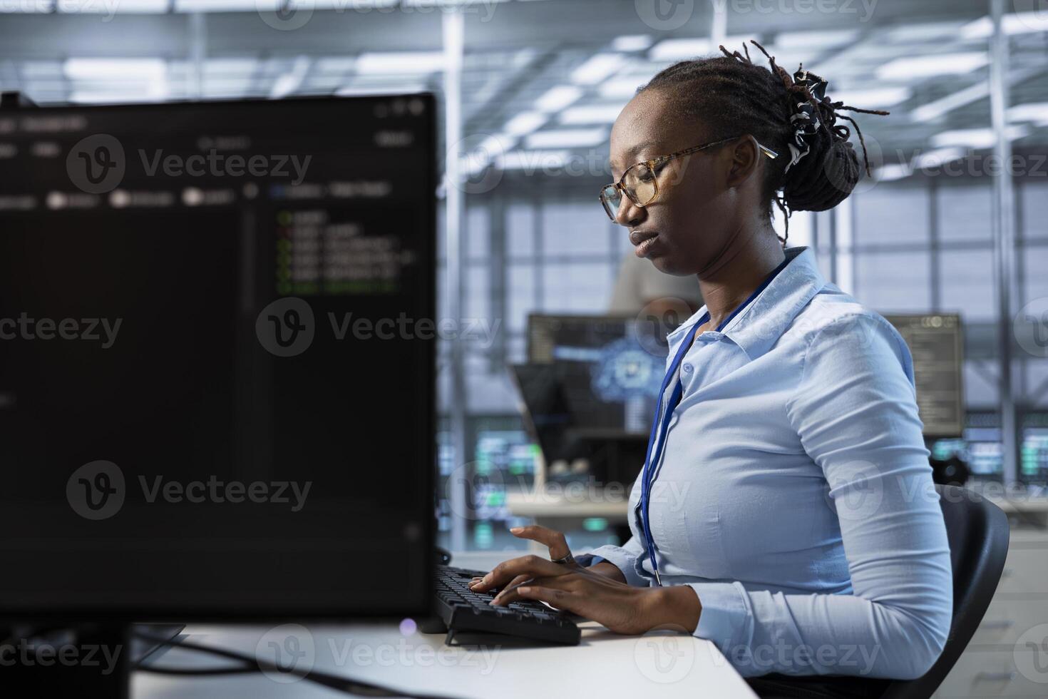 Engineer in server room ensuring compliance with industry standards and regulatory requirements. Data center employee conducting security audits to protect against cyber threats photo