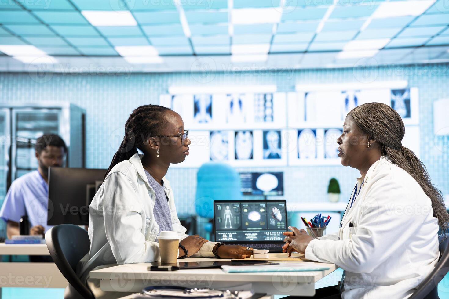 Female physician measures the oxygen saturation and heart rate with oximeter at routine checkup, consulting a black girl with modern medical gadgets. Vital signs monitoring. photo