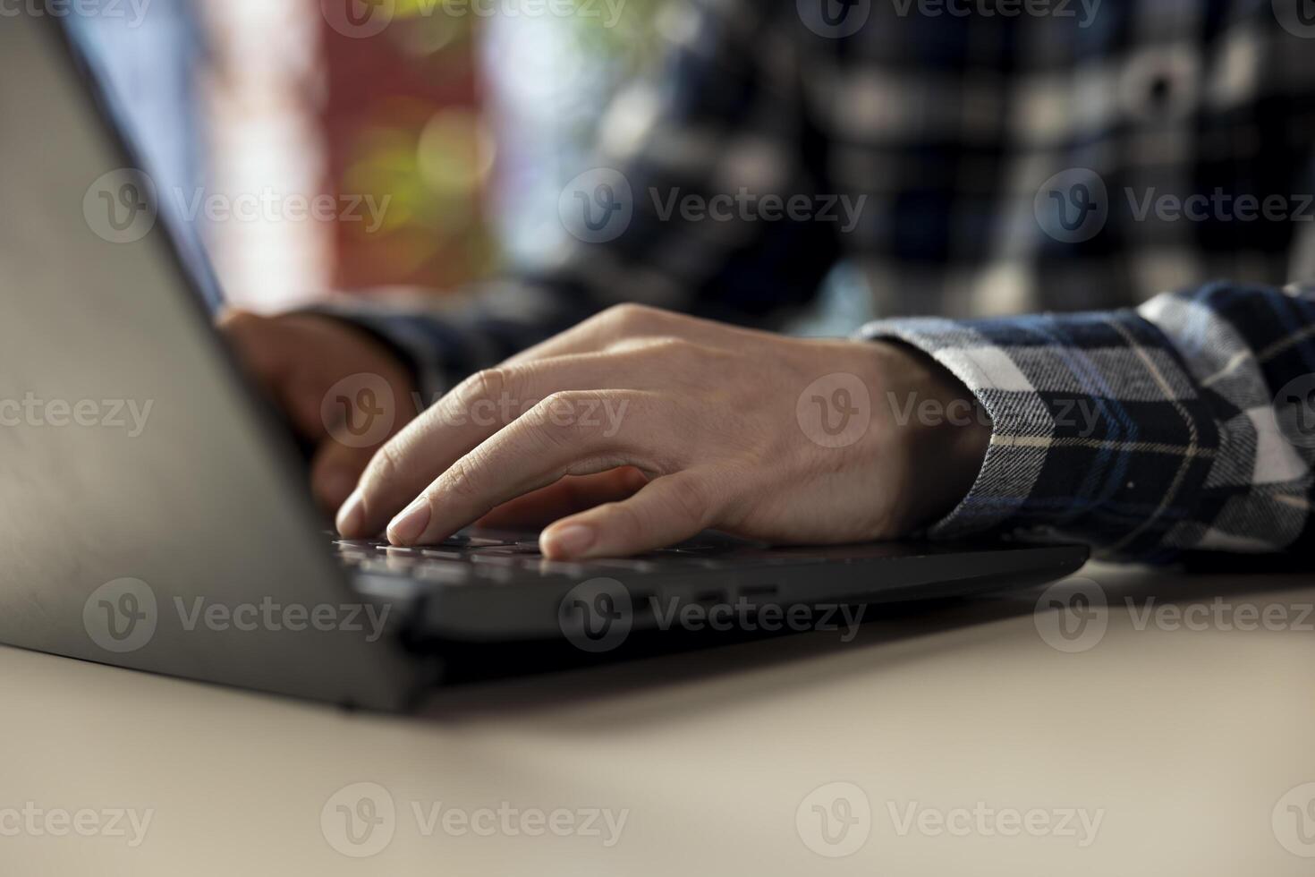 Worker at home office desk editing documents on notebook, updating reports and files, typing text. Close up of employee managing digital documents within file directories on laptop photo