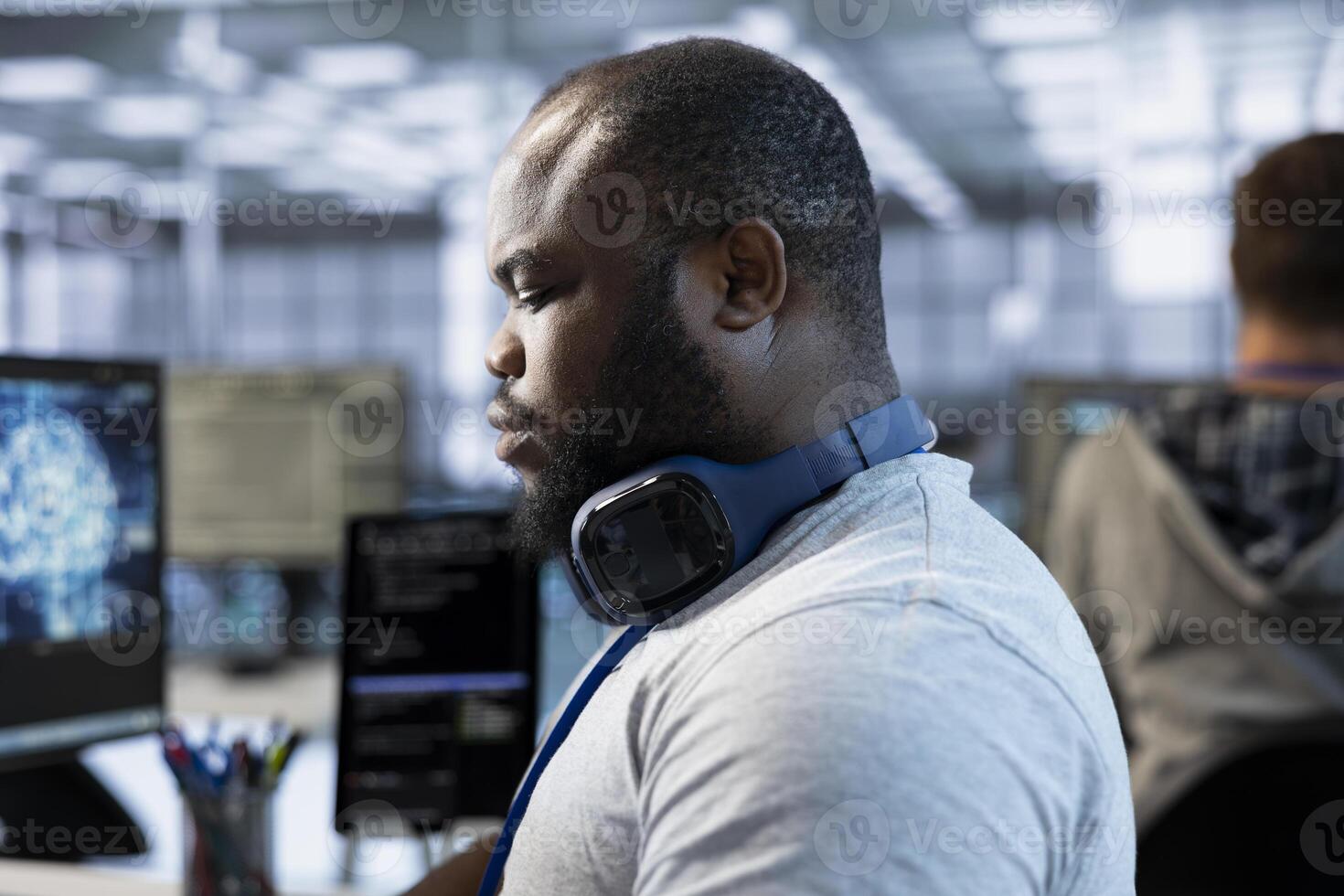Software developer implementing cybersecurity measures to protect data center assets and information. Server farm worker monitoring and analyzing metrics to enhance operational effectiveness photo
