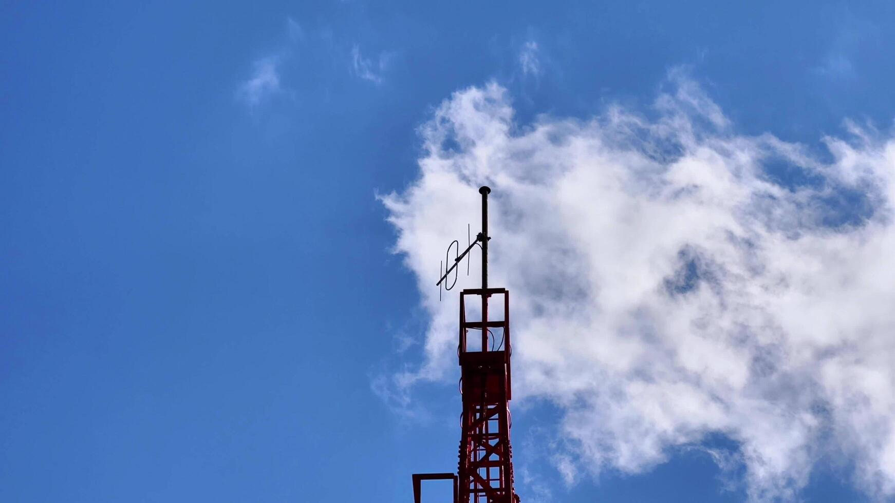 HighResolution and Detailed Images of a Communication Tower Surrounded by Fluffy Clouds photo