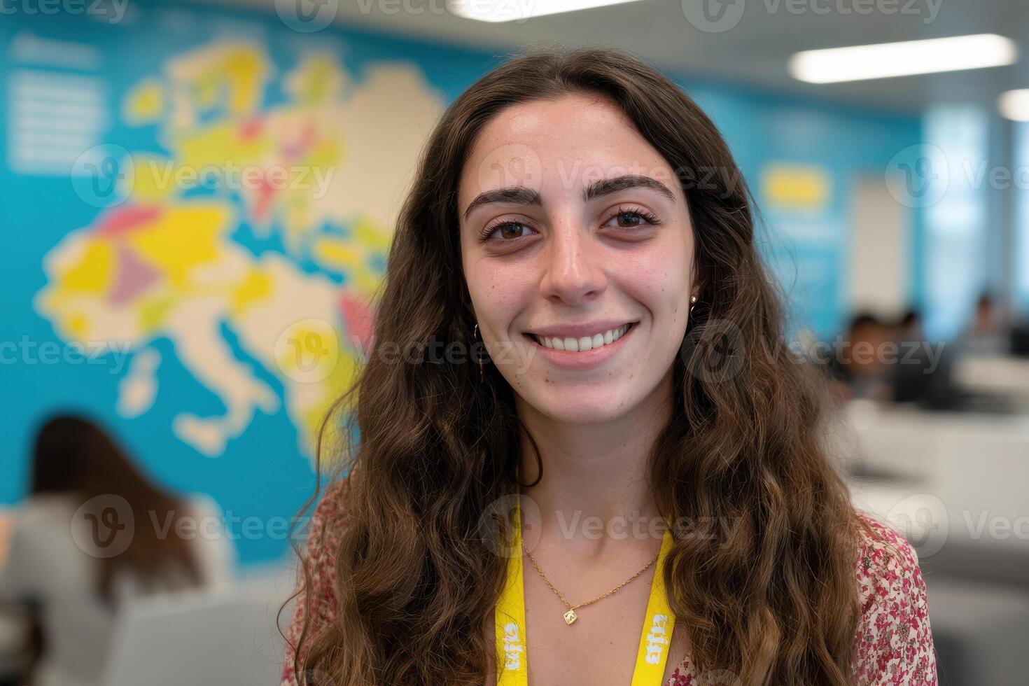 cheerful travel agency employee stands in vibrant office smiling in front of large world map photo