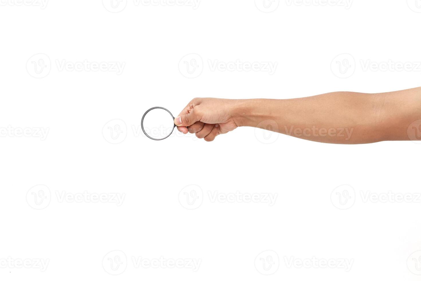 Hand holding a magnifying glass photo