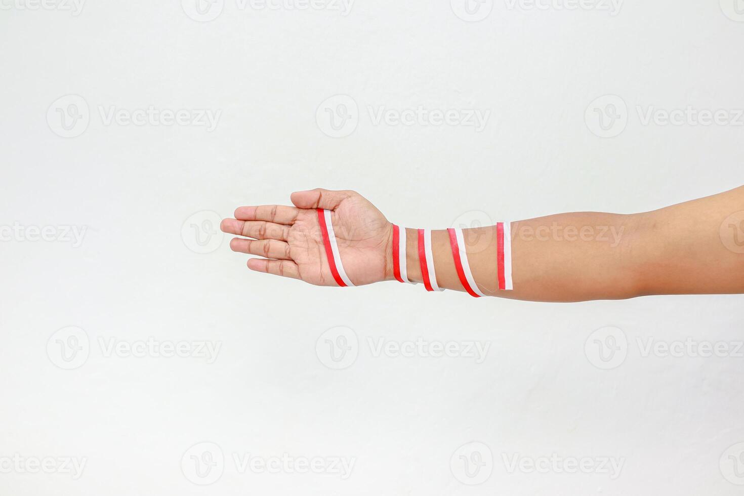 An isolated human hand with red and white ribbons, celebrating Indonesian independence day on a clear background photo
