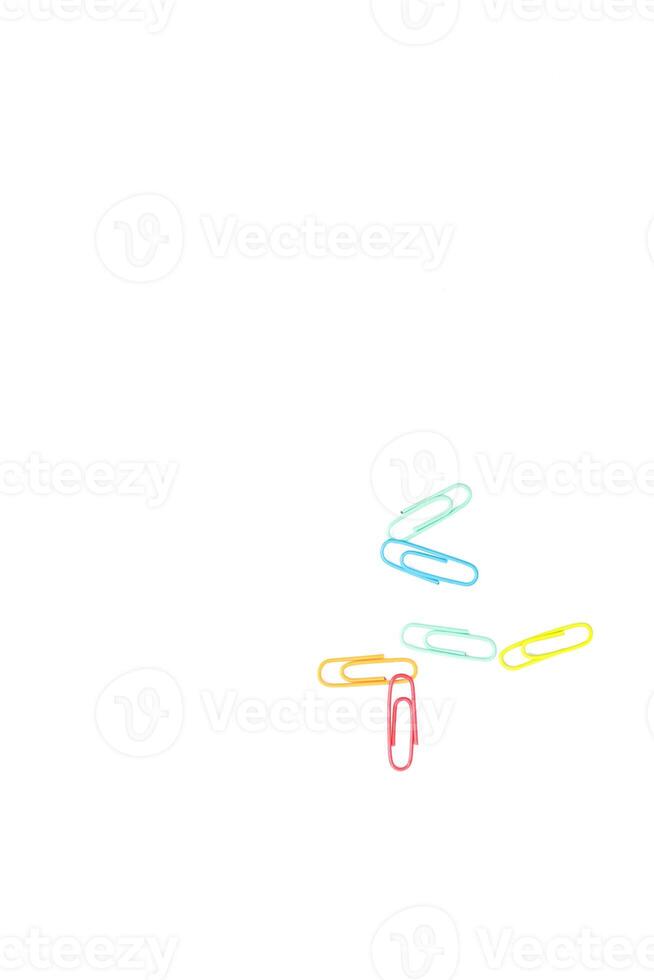 Vibrant Paper Clips Scattered on a White Background, Creating a Minimalist Aesthetic photo