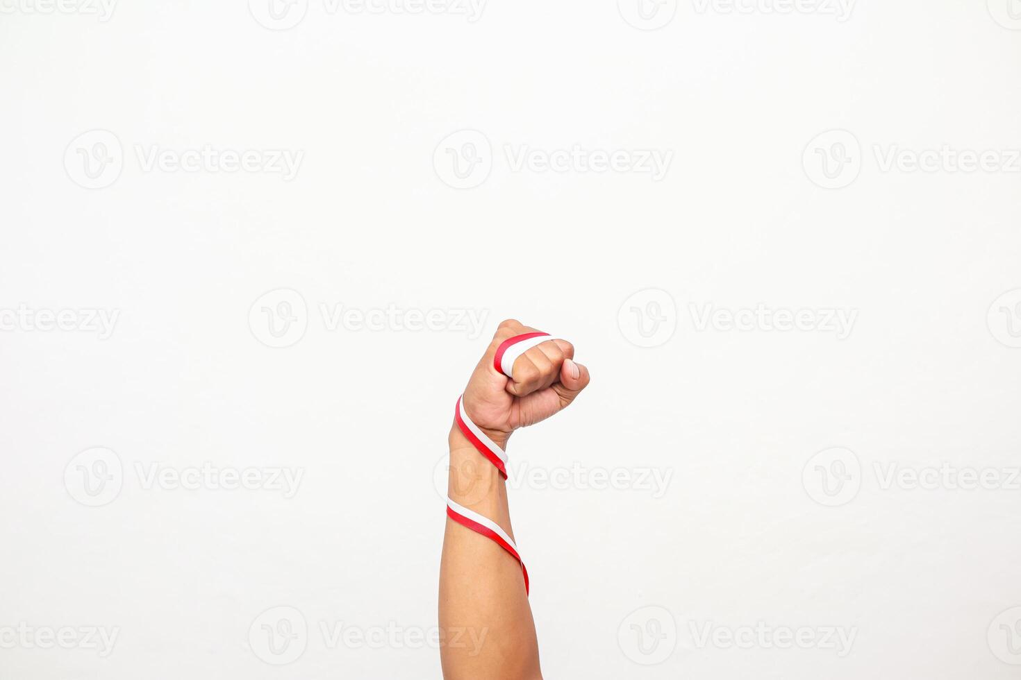 A fist with a red and white ribbon wrapped around the arm, symbolizing strength and patriotism photo
