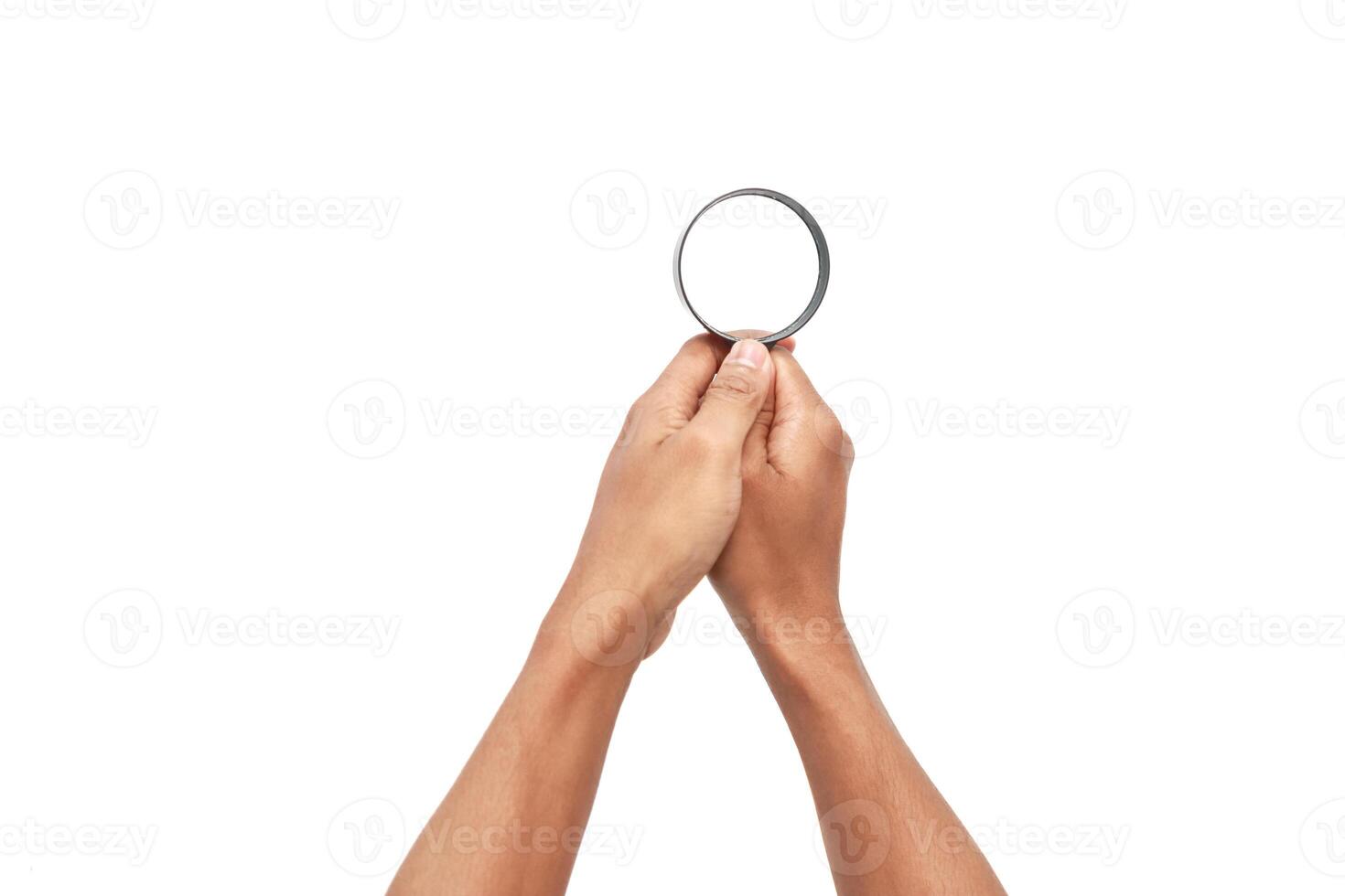 Hands holding magnifying glass isolated on white background for search concept photo