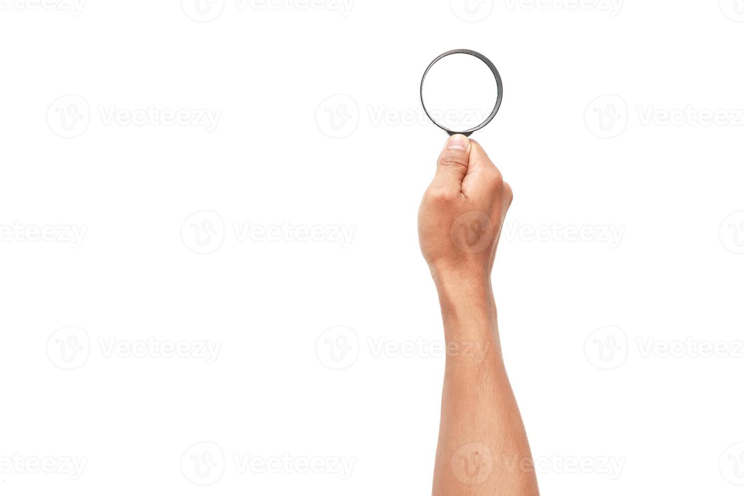 Hand holding a magnifying glass on a white background, concept of search photo