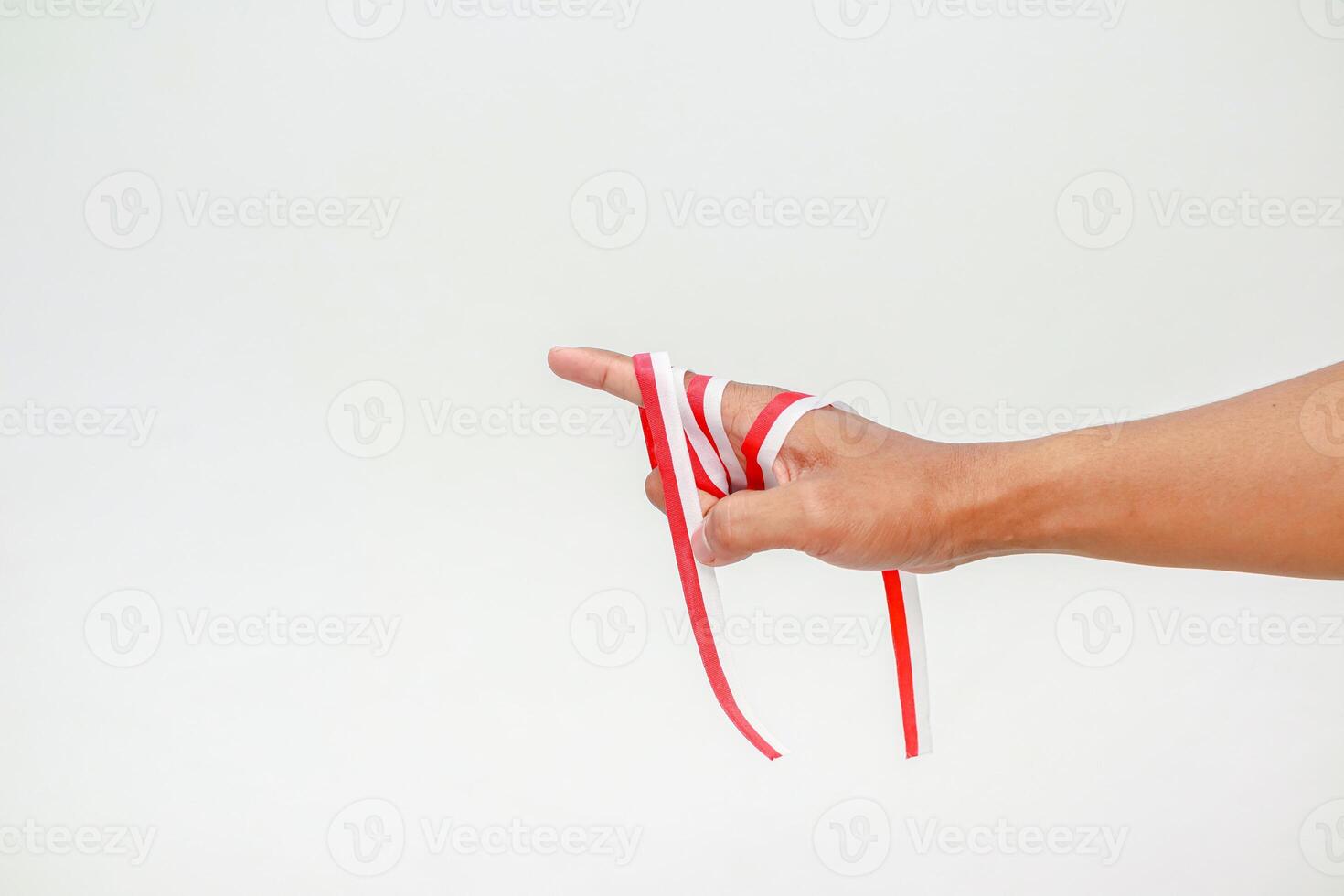 Hand with Red and White Ribbon Symbolic of Indonesian Independence Day Celebration photo