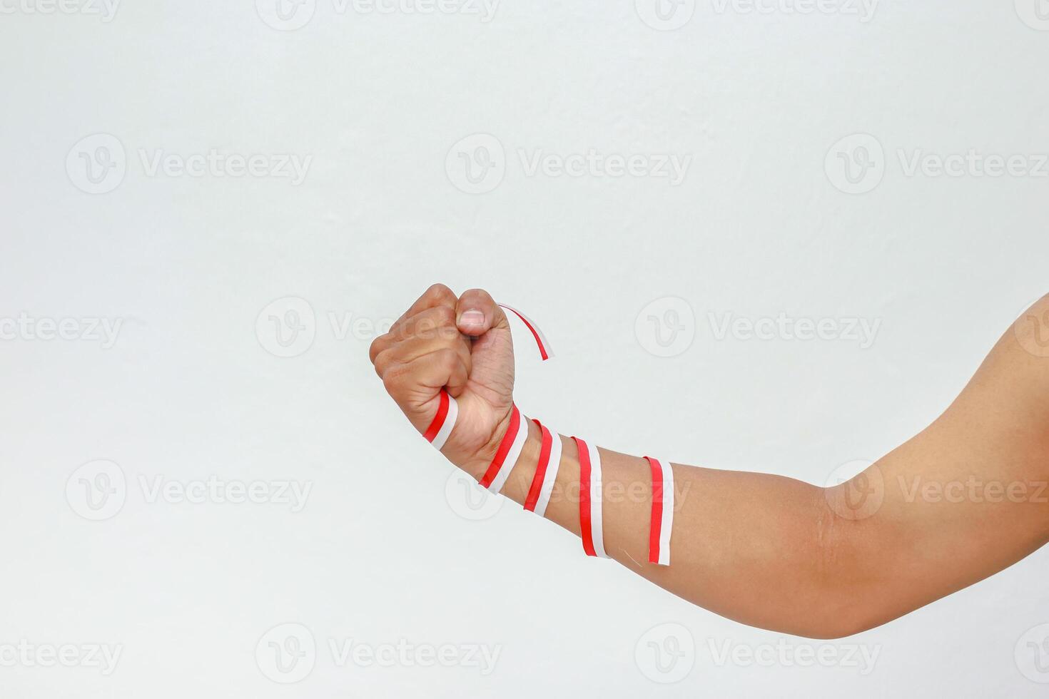 Strong fist wrapped in red and white ribbons expressing Indonesian Independence Day spirit photo