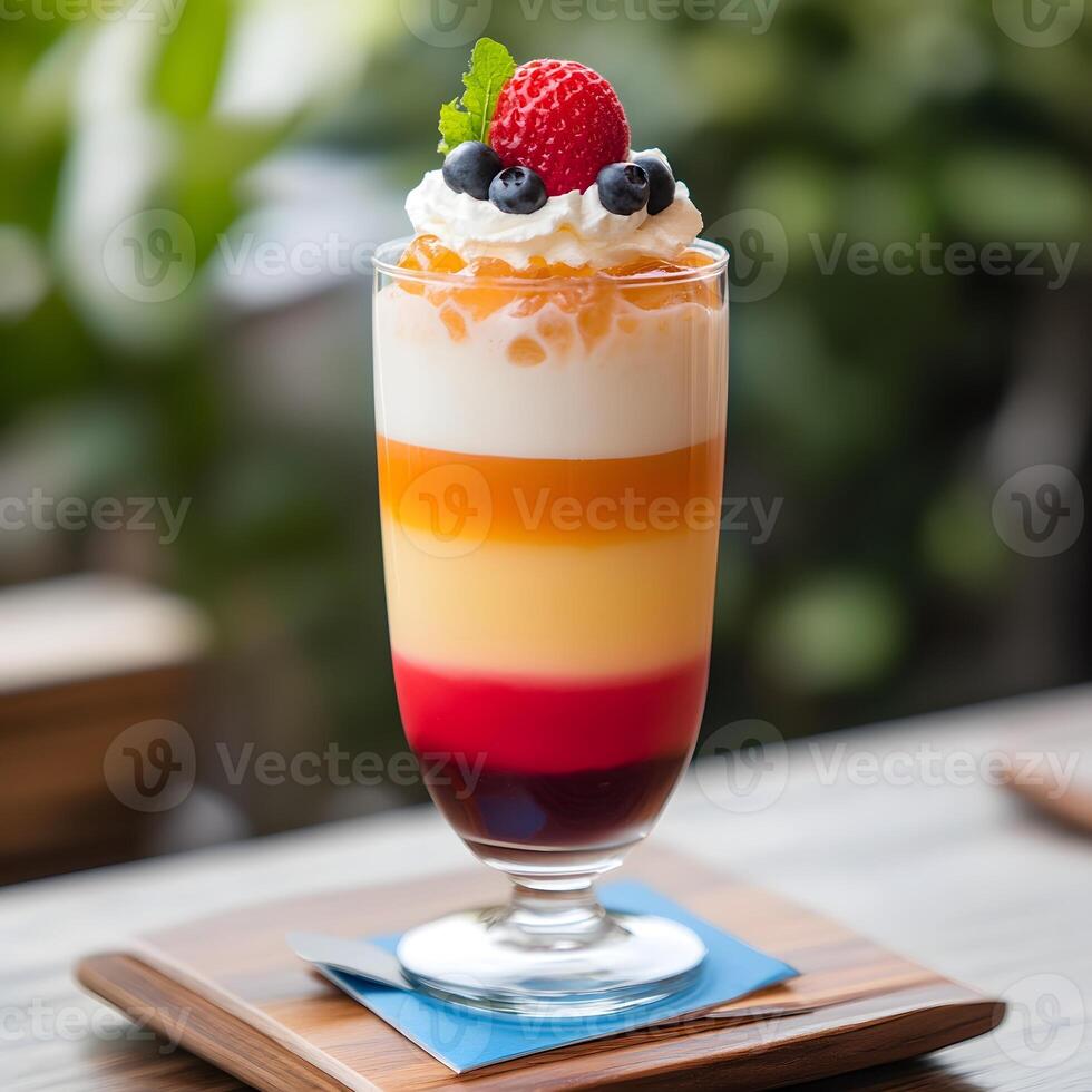 Colorful cocktail dessert in a glass on a table in a cafe or restaurant. selective focus, multiple layers drink. photo