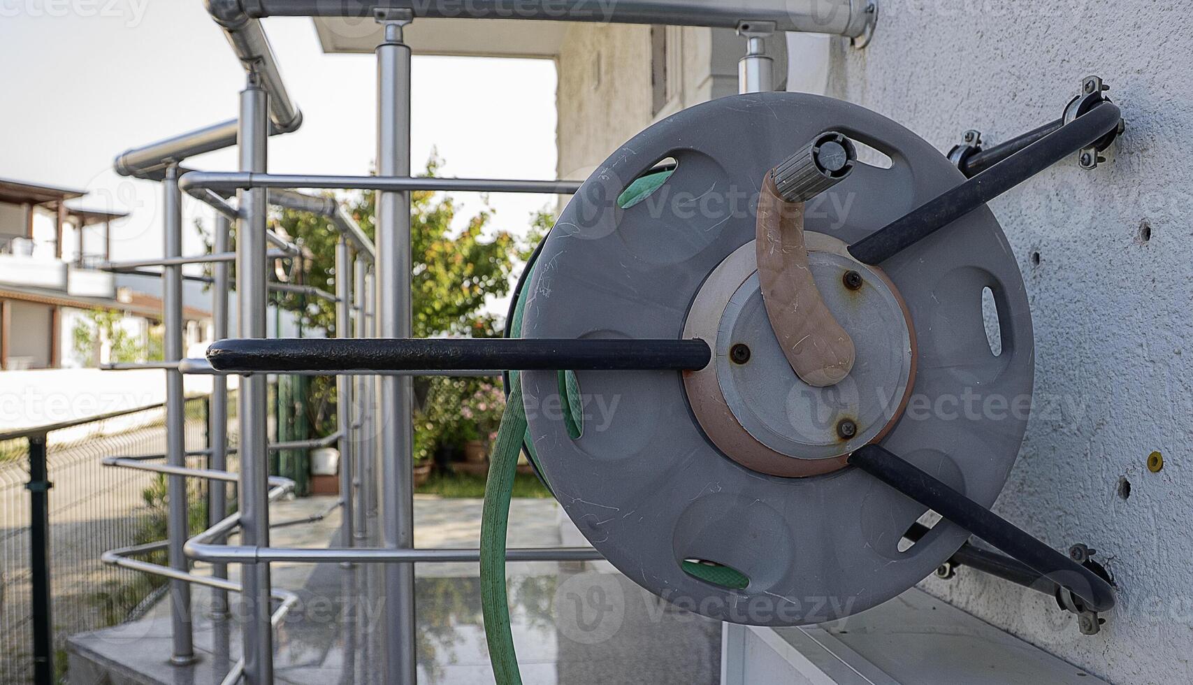 A metal pipe attached to a wall photo