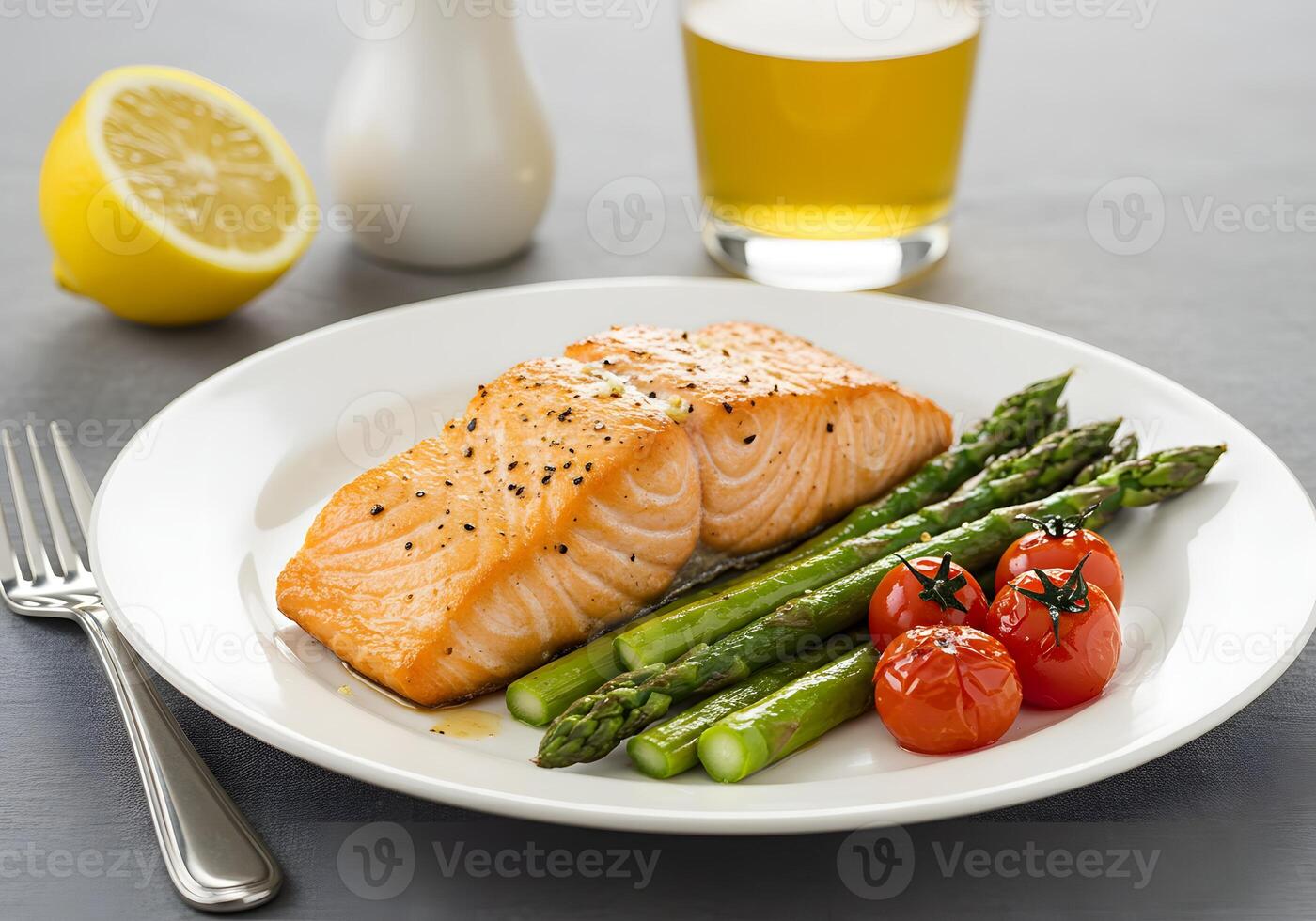 salmon, asparagus and tomatoes on a plate photo