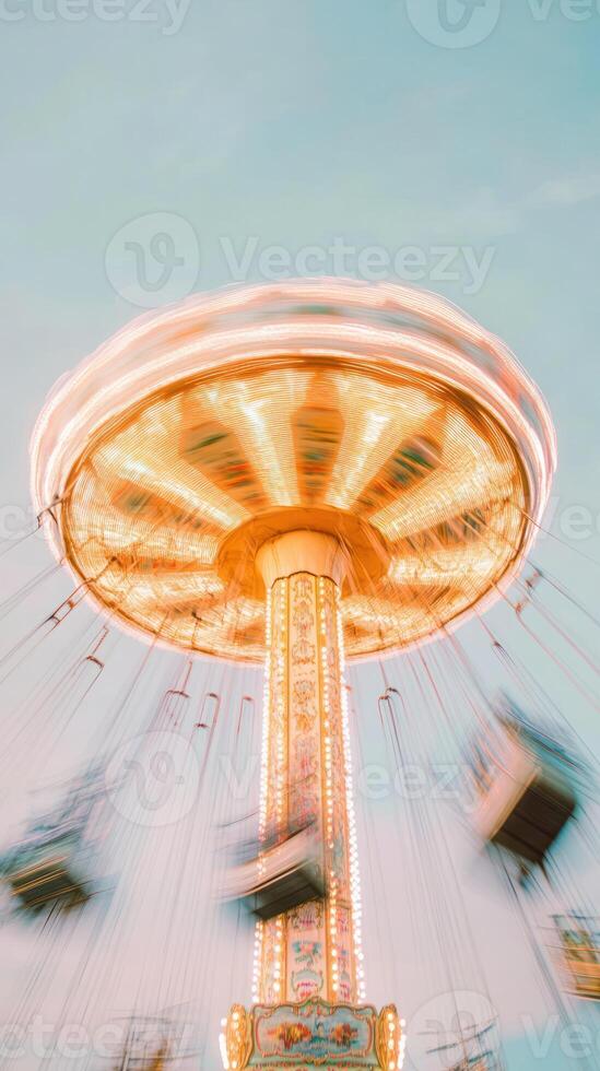 Swing ride carousel spinning with motion blur and lights against clear sky. Long exposure photography. Amusement and funfair concept. photo