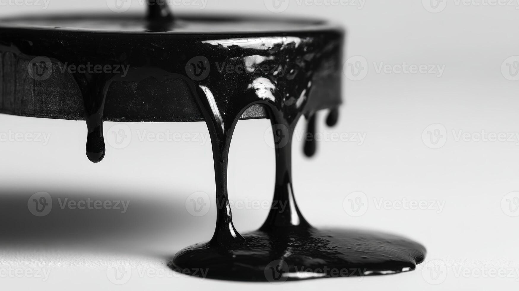 Close-Up of Black Candle Wax Dripping on White Surface with Shadows photo