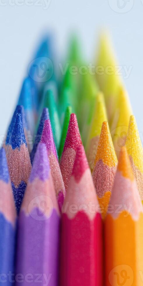 Vibrant close up of sharpened colored pencils arranged in rainbow order for creative projects photo
