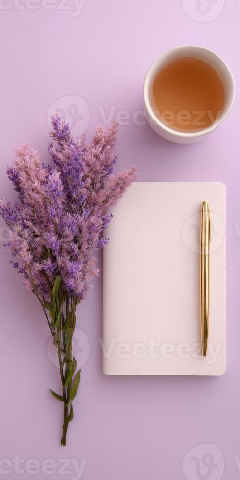 Minimal workspace for journaling with notebook lavender tea flat lay design photo