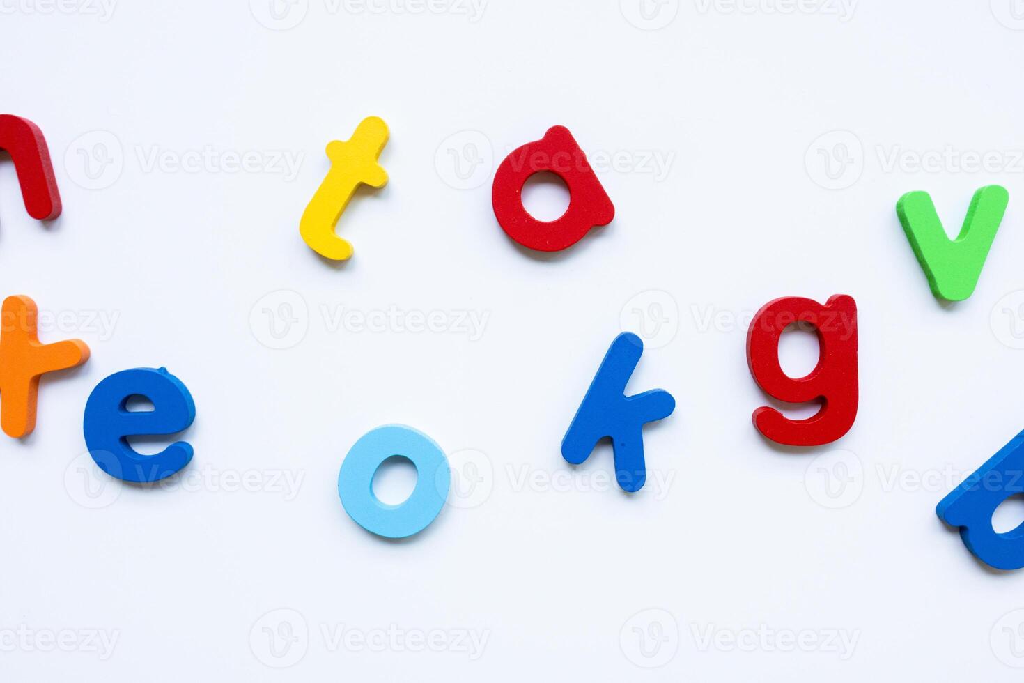 Colorful plastic alphabet letters on white background for educational activities photo