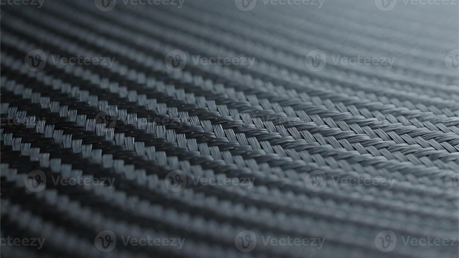 Close-up macro shot of dark gray carbon fiber weave texture, showing detailed intricate pattern of interwoven fibers, ideal background for industrial, technological, or automotive designs photo