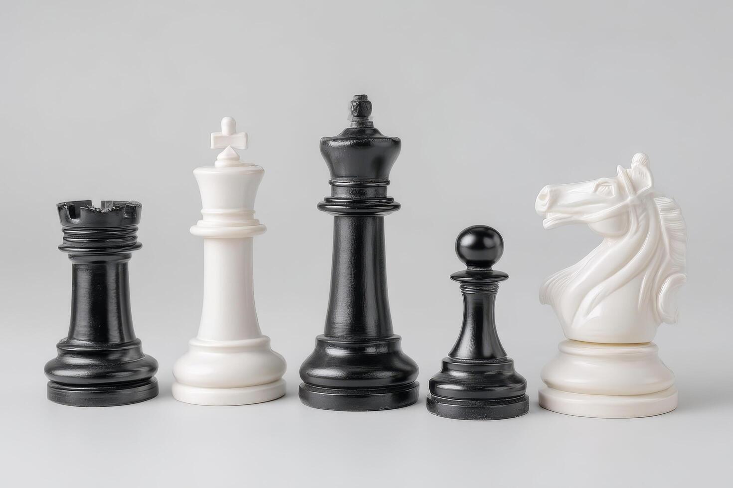 Chess pieces in black and white arranged on light background, showcasing strategy and elegance photo