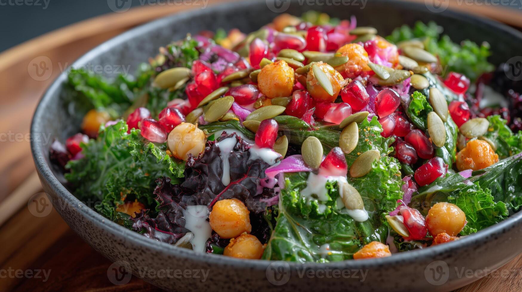 Vibrant salad features fresh kale, protein-rich chickpeas, juicy pomegranate seeds, and crunchy pumpkin seeds. photo