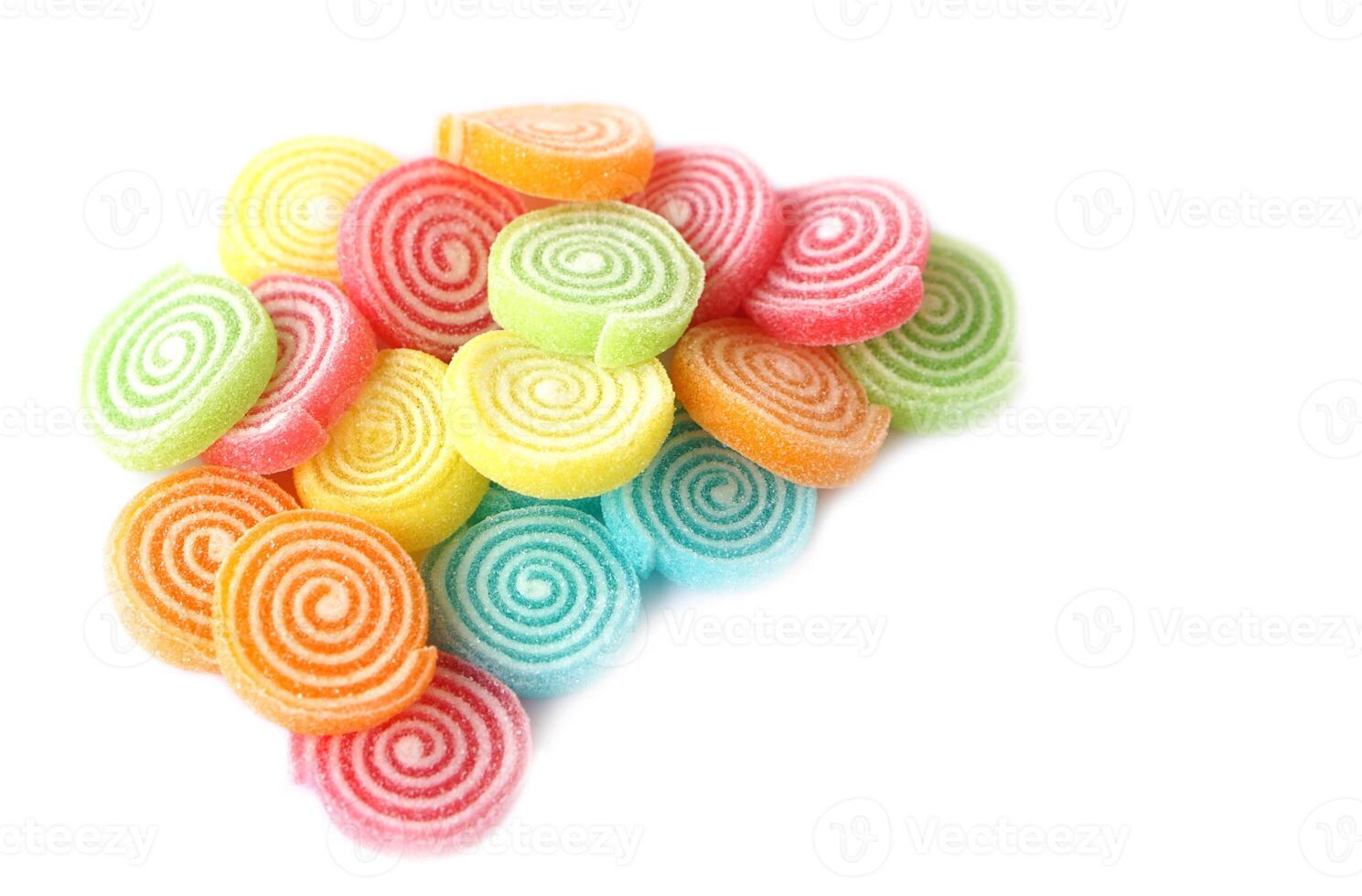 Colorful jelly candies in spiral circle shapes, coated with sugar, isolated on white background. These vibrant sweets evoke childhood joy. Ideal for snack or dessert themed design. Kids favorite jelly photo
