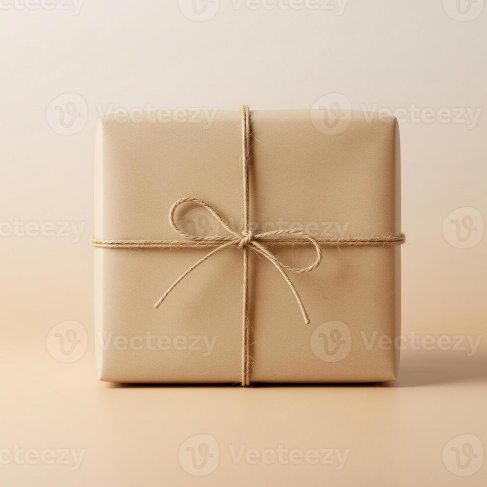 Minimalist Kraft Paper Gift Box with Natural Twine Bow on Seamless Neutral Background photo