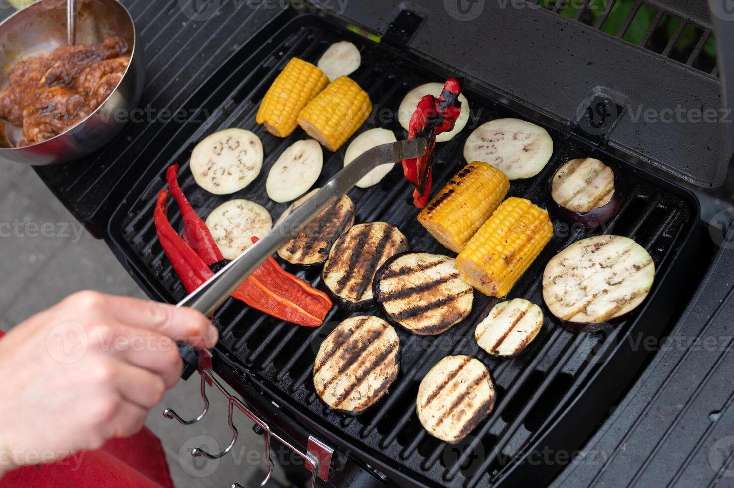 Grilled vegetables on barbecue with bell peppers and corn on the cob photo