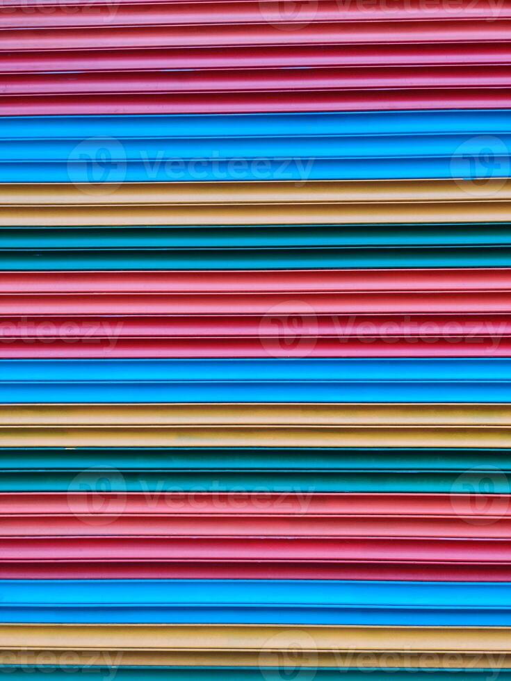 close-up of the texture of a corrugated multi-colored fence photo
