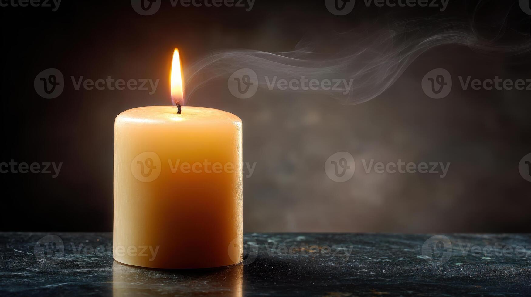A single candle is lit on a table photo