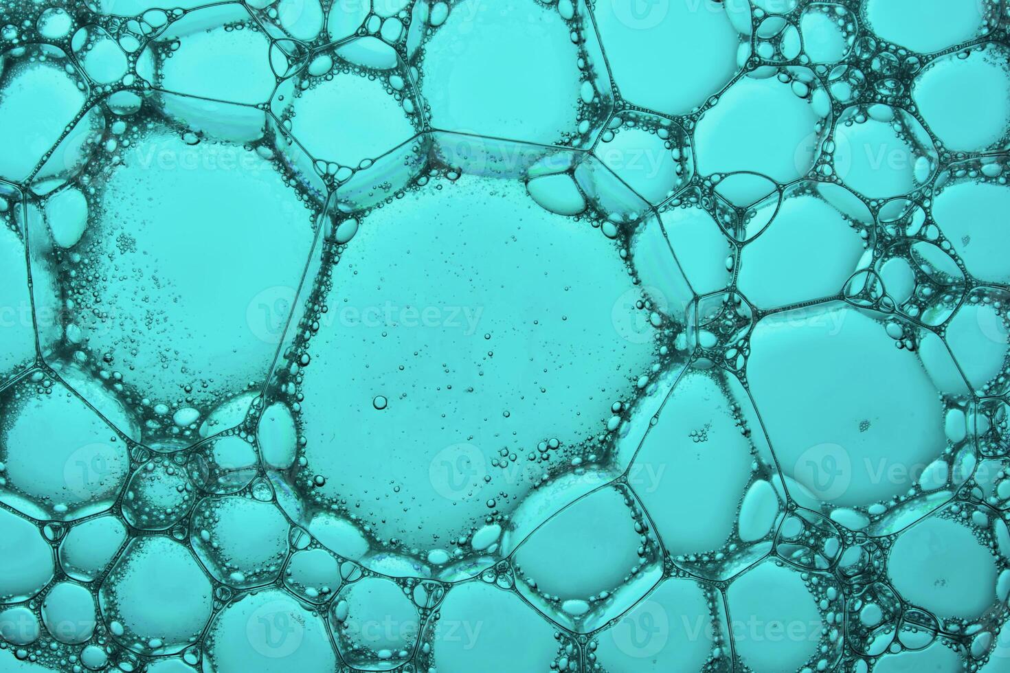The texture of soap bubbles and foam in close-up on a green background. photo