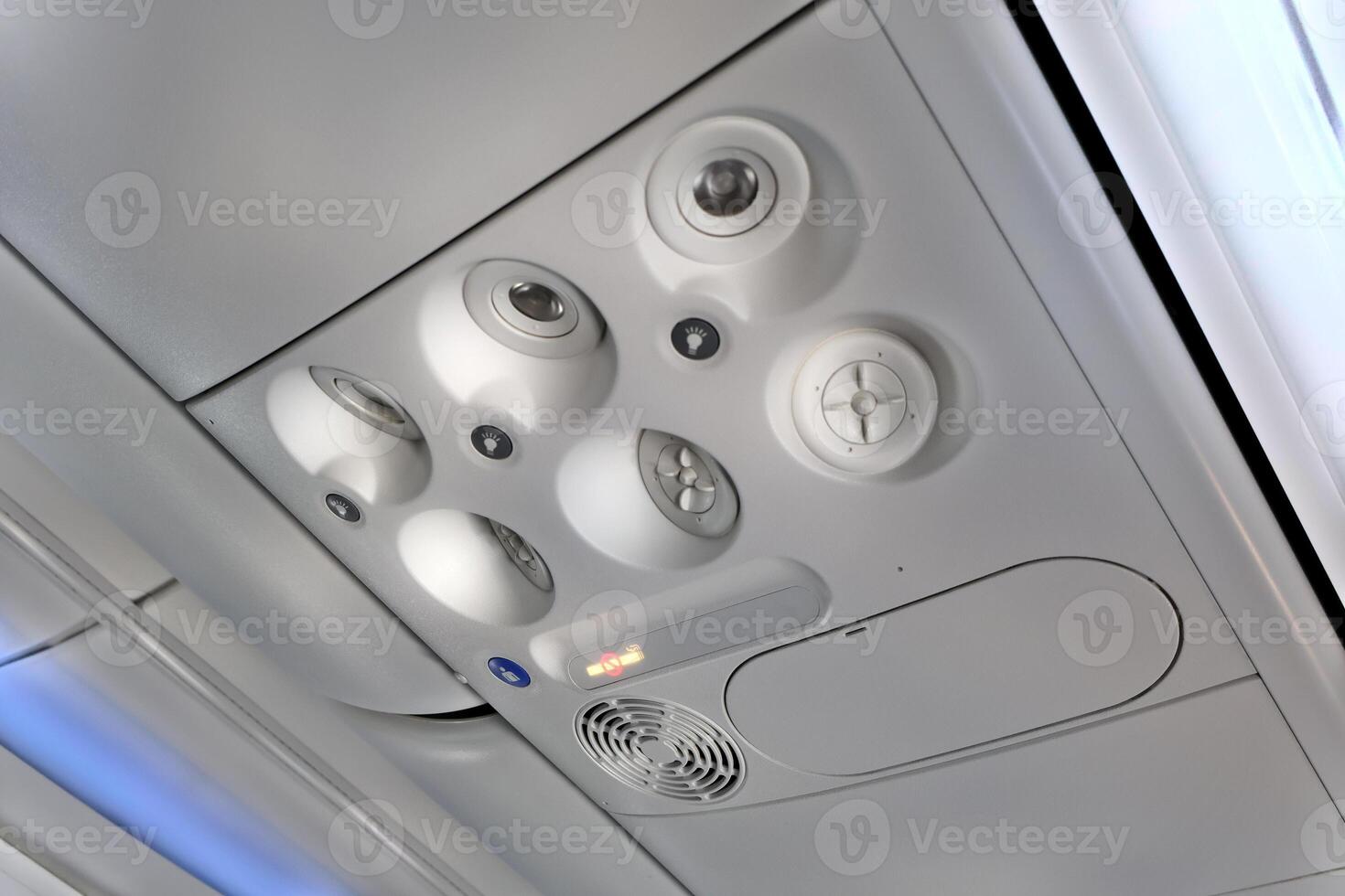 Close-Up of an Airplane Overhead Panel With Air Vents and Buttons photo