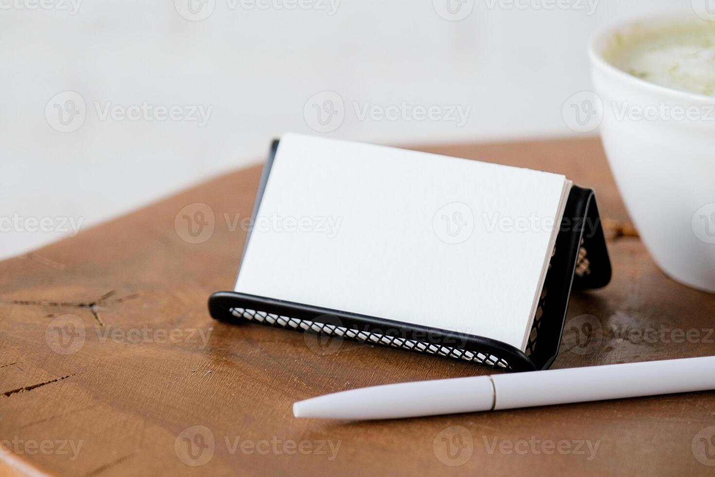 blank visit card mockup on coffee table with green matcha tea near window photo