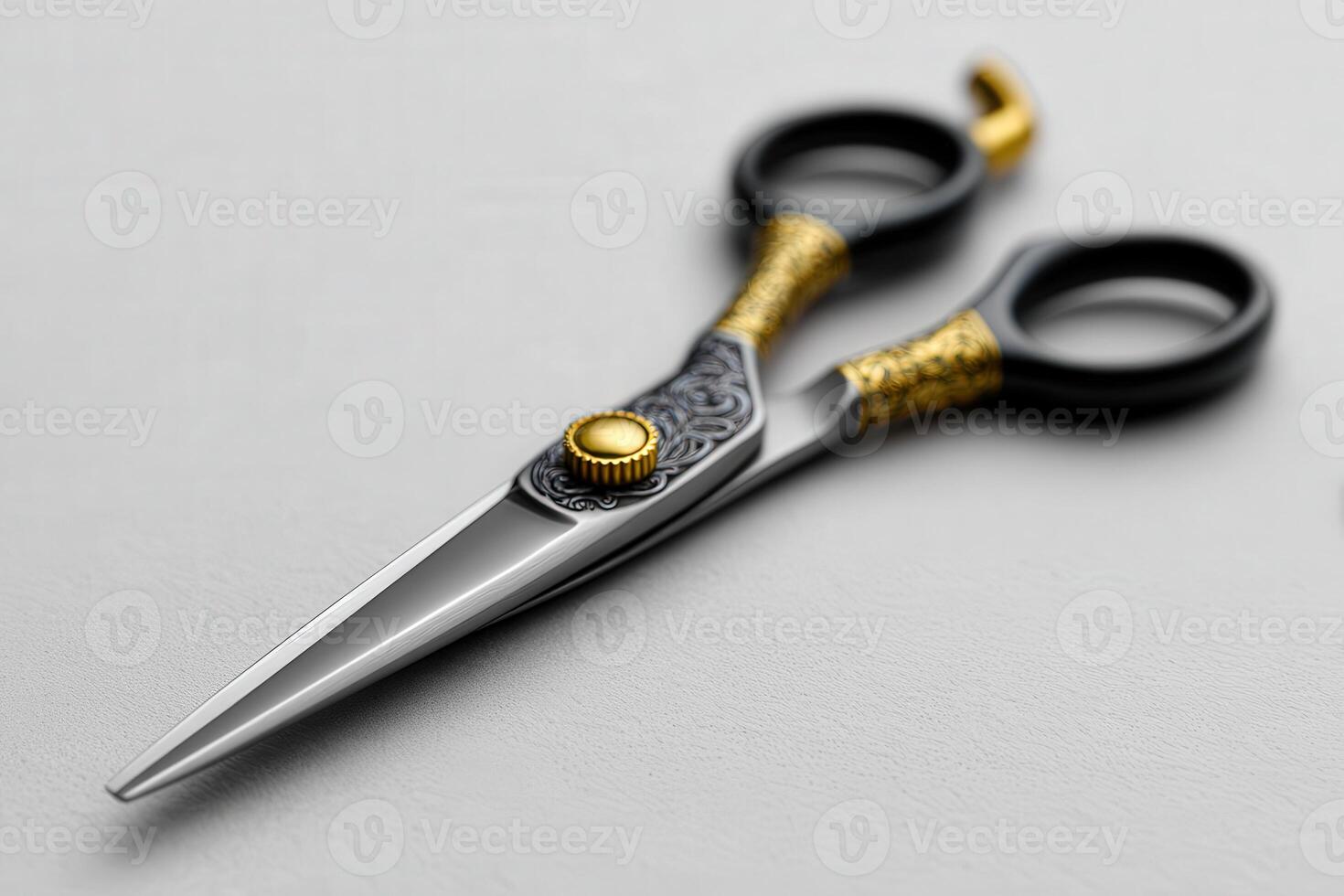 Close-up of ornate barber scissors on grey surface photo