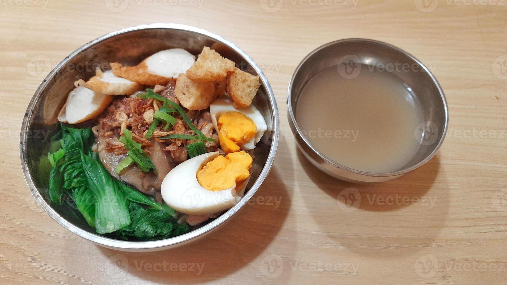 Delicious Bowl of Noodles with Egg and Soup photo