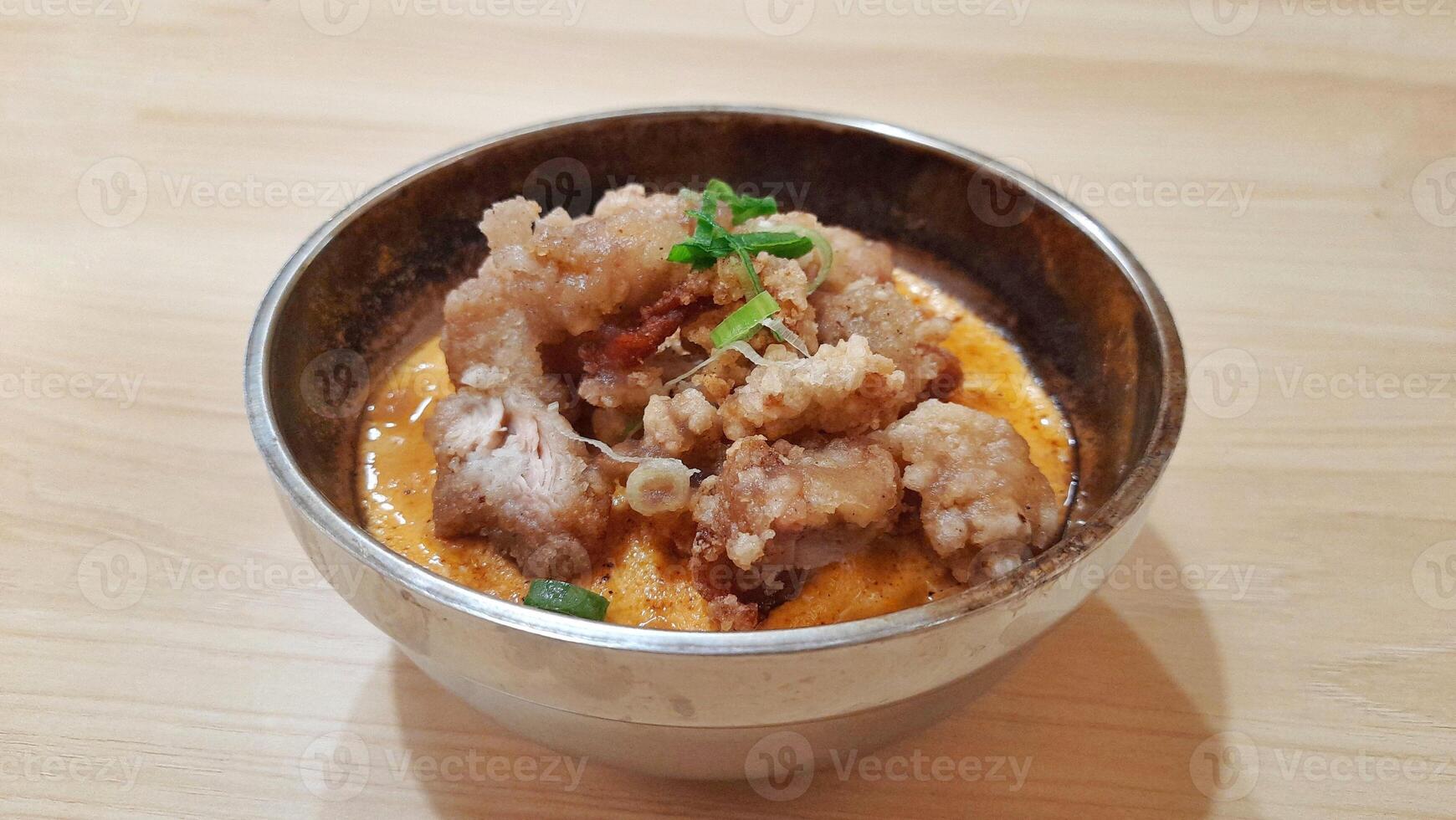 Chicken Karage Rice With Torched Mentai Sauce, Served On a Metal Bowl at Wooden Table photo